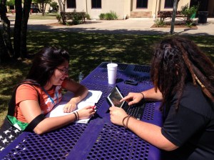 Students Felix Gonzales, Logistics major and Nina Sigala, Education Major use different learning materials 