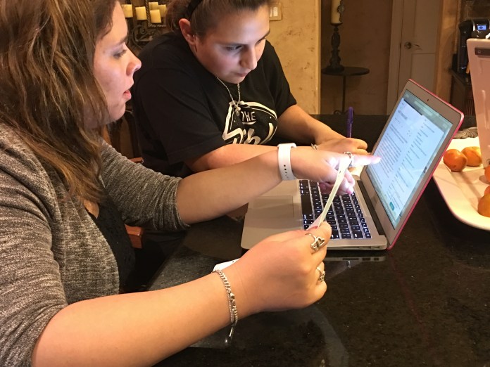 Photo illustration of students using a laptop